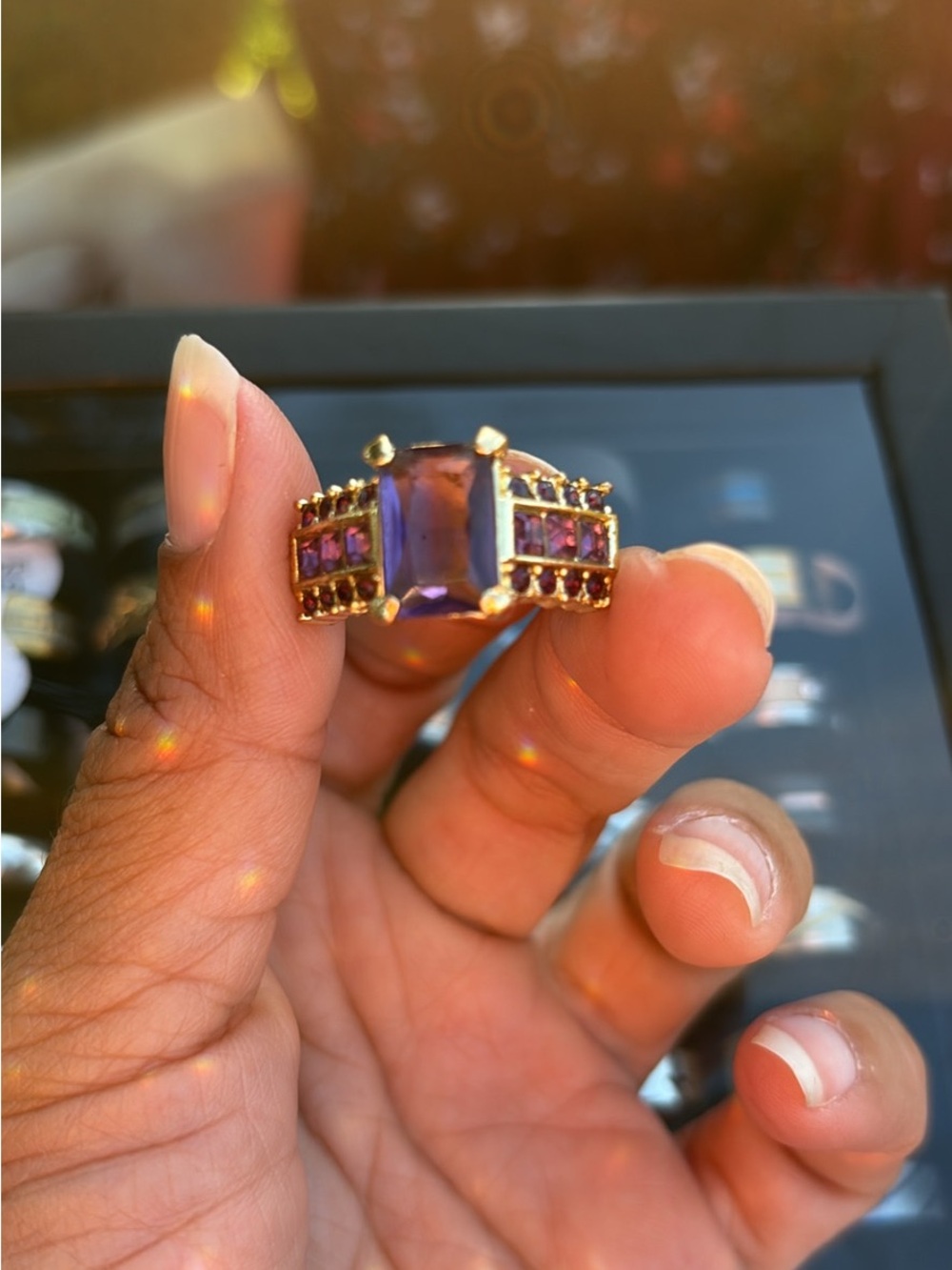 Gold Ring with Purple Center Stone and Accent Purple Gems